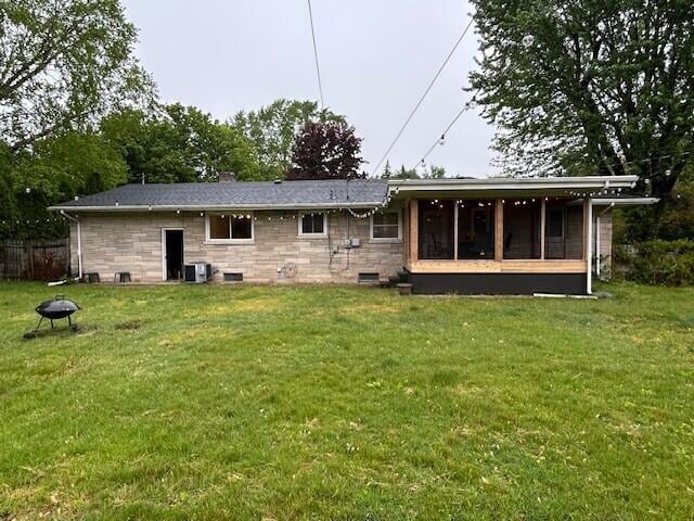 538 Monterey Dr, Benton Harbor, MI 49022 - rear view of property with a sunroom, central air condition unit, crawl space, and stone siding