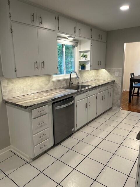538 Monterey Dr, Benton Harbor, MI 49022 - kitchen with dishwashing machine, a sink, baseboards, decorative backsplash, and open shelves