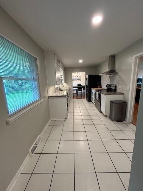 538 Monterey Dr, Benton Harbor, MI 49022 - kitchen featuring wall chimney range hood, electric stove, a sink, freestanding refrigerator, and recessed lighting