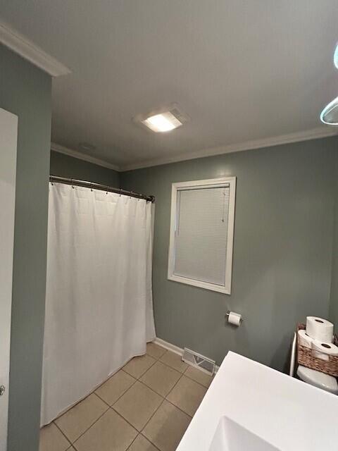538 Monterey Dr, Benton Harbor, MI 49022 - bathroom featuring tile patterned flooring, ornamental molding, baseboards, a shower with shower curtain, and vanity