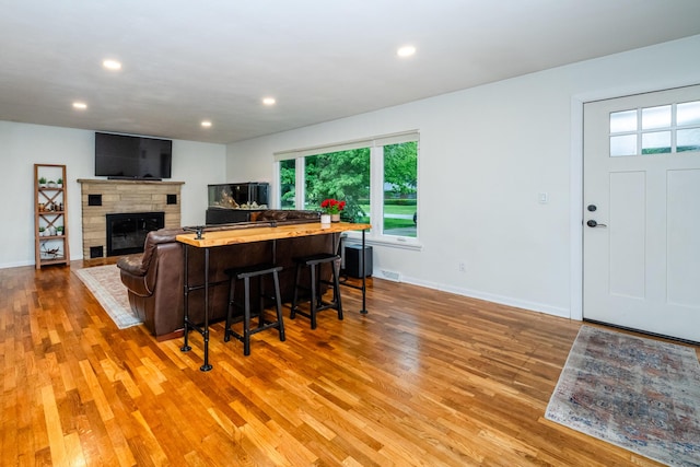 538 Monterey Dr, Benton Harbor, MI 49022 - living area featuring wood finished floors, a glass covered fireplace, baseboards, and recessed lighting