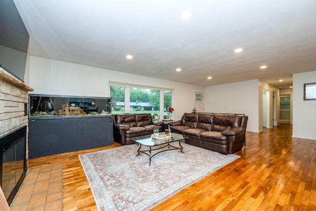 538 Monterey Dr, Benton Harbor, MI 49022 - living room featuring a multi sided fireplace, wood finished floors, and recessed lighting