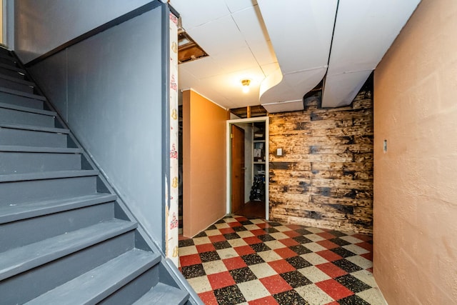 538 Monterey Dr, Benton Harbor, MI 49022 - finished below grade area featuring tile patterned floors, stairs, and wood walls