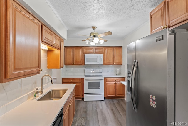 30542 Bretton St, Livonia, MI 48152 - kitchen featuring white appliances, a sink, a textured ceiling, light countertops, and dark wood-style floors