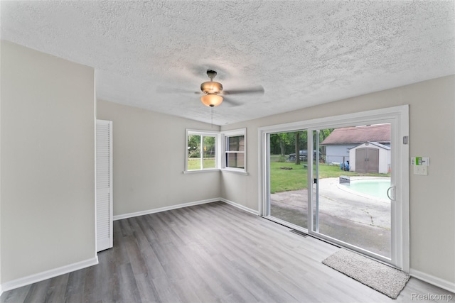 30542 Bretton St, Livonia, MI 48152 - spare room with wood finished floors, baseboards, ceiling fan, and a textured ceiling