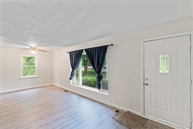 30542 Bretton St, Livonia, MI 48152 - entrance foyer with a textured ceiling, wood finished floors, ceiling fan, and baseboards