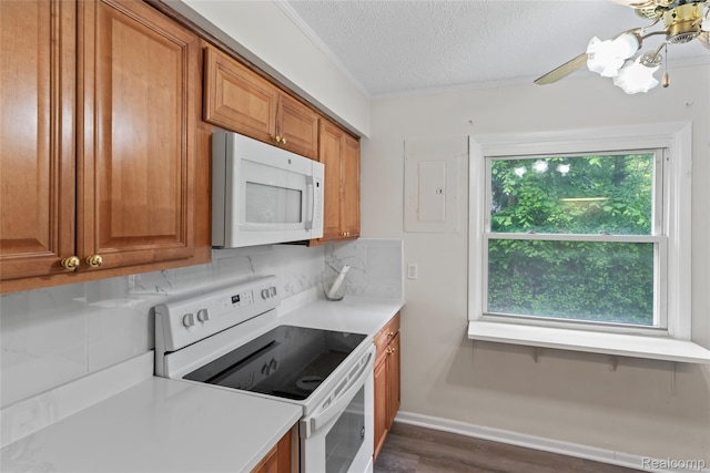 30542 Bretton St, Livonia, MI 48152 - kitchen with white appliances, dark wood-style floors, brown cabinets, a textured ceiling, and crown molding