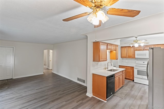 30542 Bretton St, Livonia, MI 48152 - kitchen with white appliances, ceiling fan, a sink, light wood-style floors, and light countertops