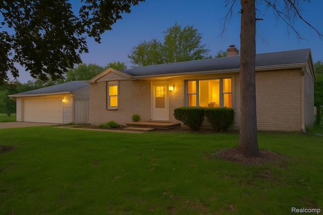 30542 Bretton St, Livonia, MI 48152 - ranch-style home with a chimney, a garage, a yard, and brick siding