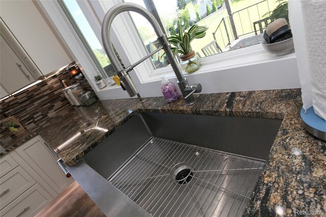 1041 Lancaster St, Lapeer, MI 48446 - kitchen view of a sink and dark stone counters