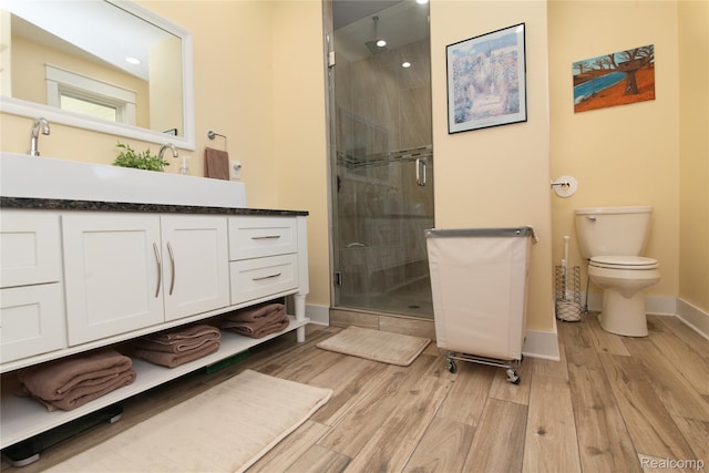 1041 Lancaster St, Lapeer, MI 48446 - bathroom with toilet, vanity, baseboards, wood finished floors, and a stall shower