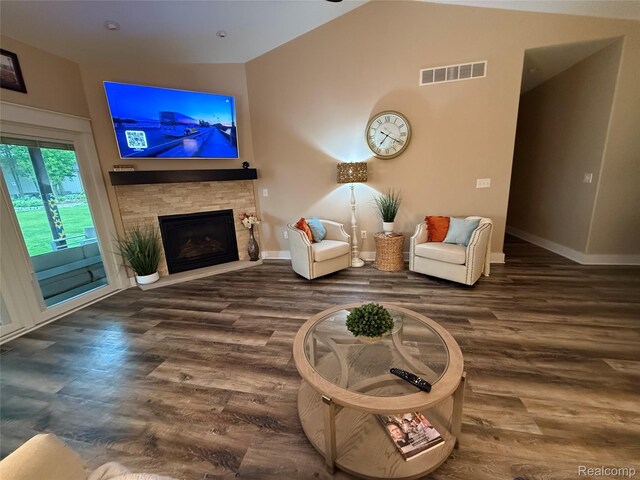 1041 Lancaster St, Lapeer, MI 48446 - living area featuring baseboards, wood finished floors, a fireplace, and vaulted ceiling