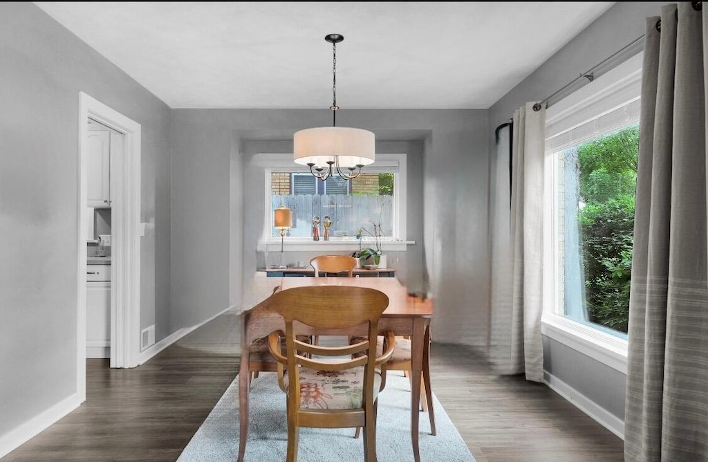 1155 Cadillac Dr SE, Grand Rapids, MI 49506 - dining space with dark wood finished floors, a chandelier, and baseboards