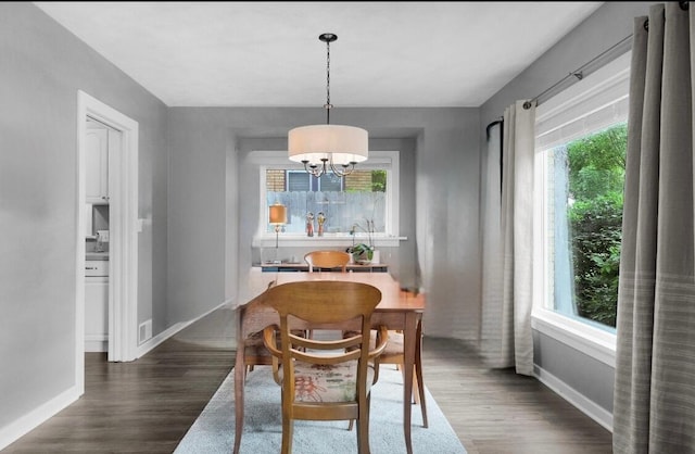 1155 Cadillac Dr SE, Grand Rapids, MI 49506 - dining space with dark wood finished floors, a chandelier, and baseboards