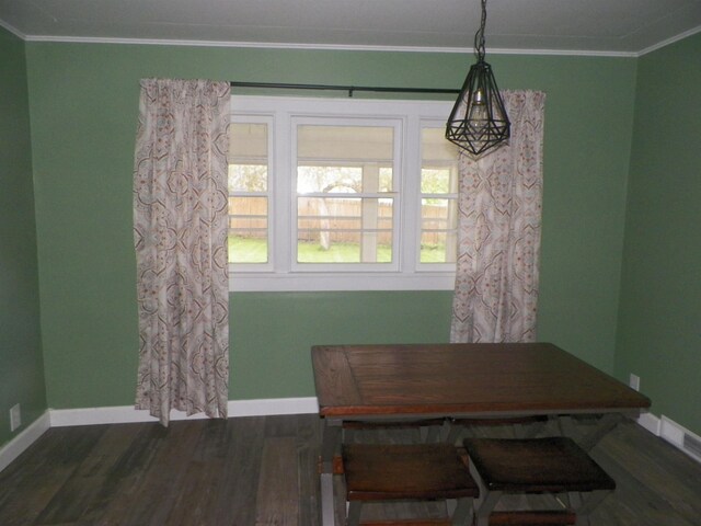 213 Cass St, Tustin, MI 49688 - dining area featuring ornamental molding, baseboards, and dark wood-type flooring