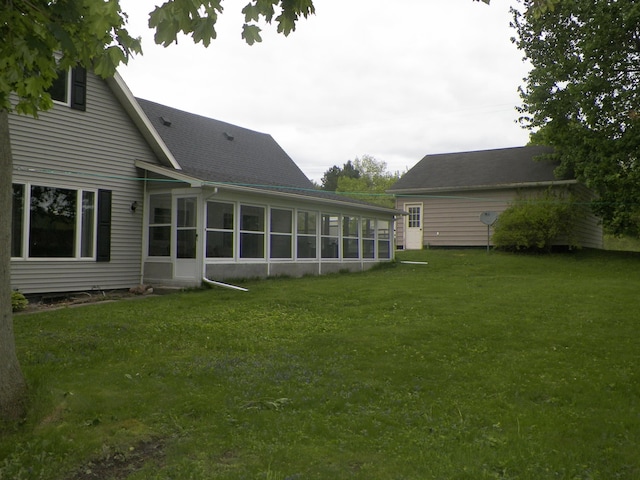 213 Cass St, Tustin, MI 49688 - back of house featuring a sunroom and a lawn