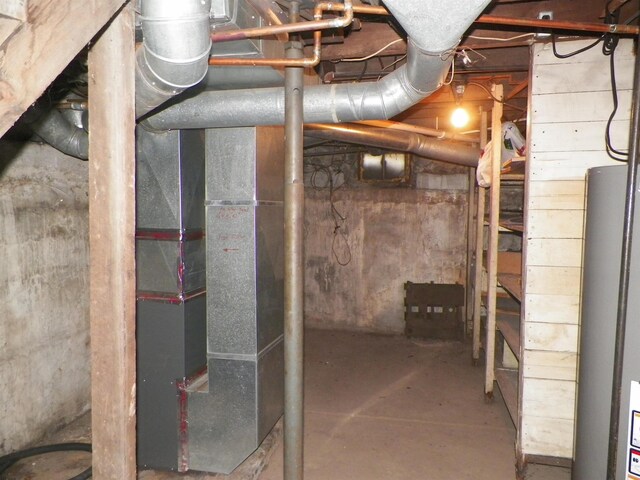 213 Cass St, Tustin, MI 49688 - unfinished basement featuring gas water heater
