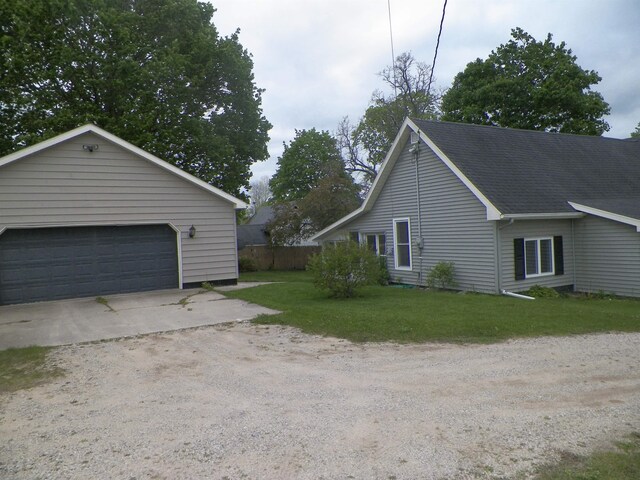 213 Cass St, Tustin, MI 49688 - view of side of property featuring a detached garage and a lawn
