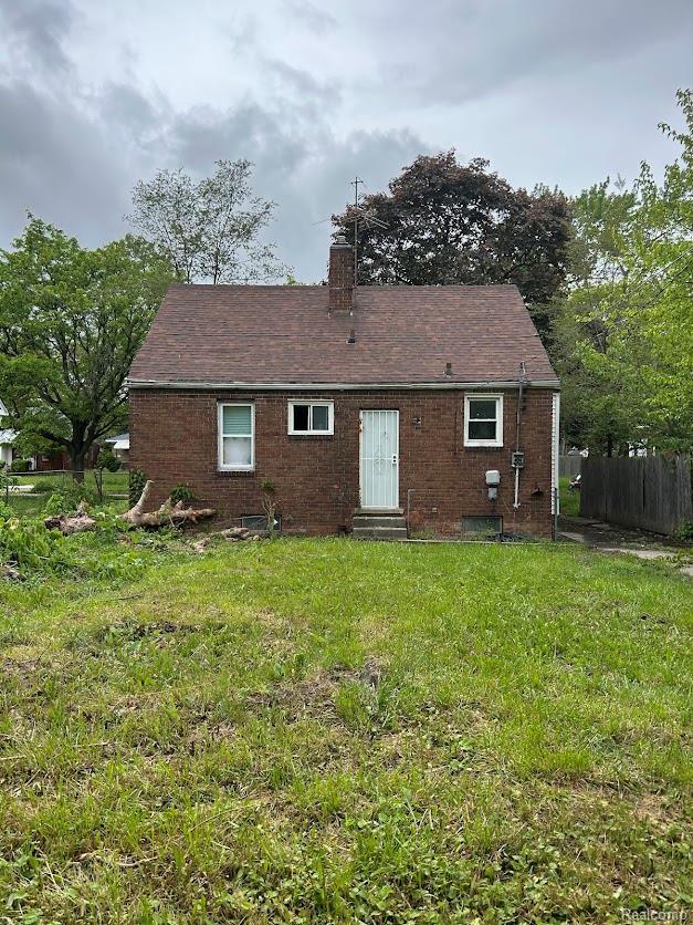 20554 Joann St, Detroit, MI 48205 - rear view of property featuring entry steps, a chimney, and brick siding