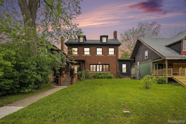 2223 S La Salle Gdns, Detroit, MI 48206 - view of front of property with a chimney, a lawn, and brick siding