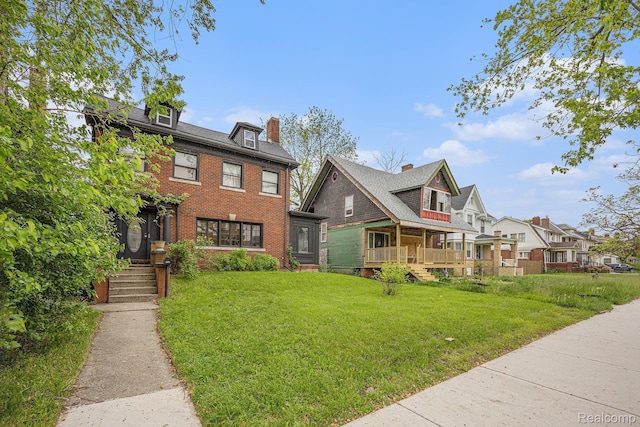 2223 S La Salle Gdns, Detroit, MI 48206 - view of front of home featuring a front lawn, brick siding, a residential view, and a chimney