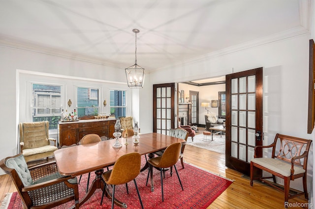 2223 S La Salle Gdns, Detroit, MI 48206 - dining area with a chandelier, light wood-style flooring, crown molding, and french doors