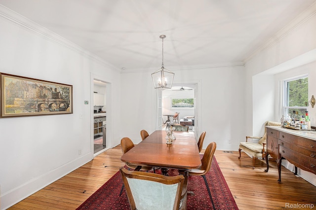 2223 S La Salle Gdns, Detroit, MI 48206 - dining room with a chandelier, light wood-type flooring, ornamental molding, and baseboards