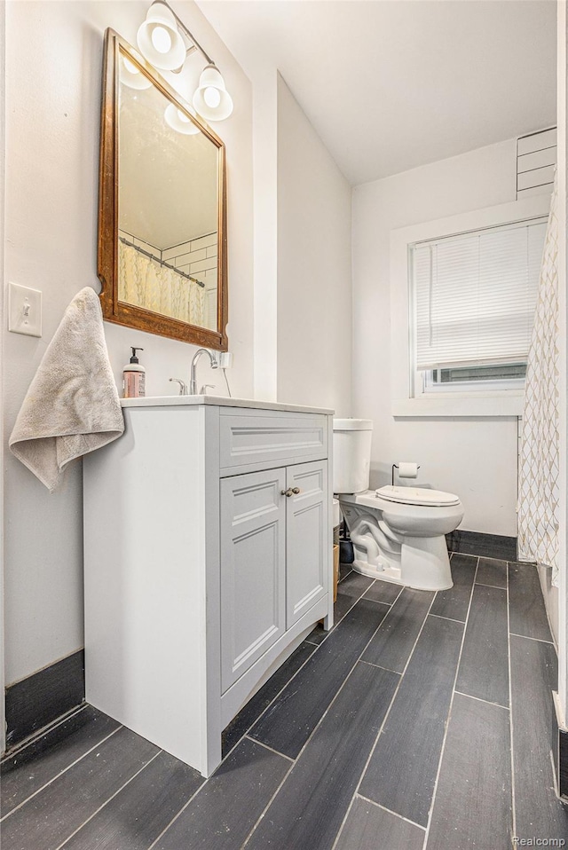 2223 S La Salle Gdns, Detroit, MI 48206 - bathroom featuring vanity, wood finished floors, and toilet