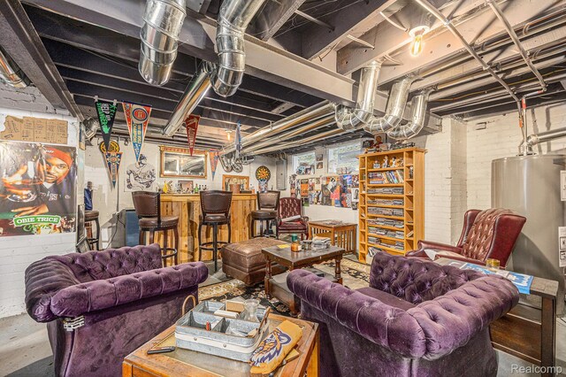 2223 S La Salle Gdns, Detroit, MI 48206 - unfinished basement with brick wall, gas water heater, and bar