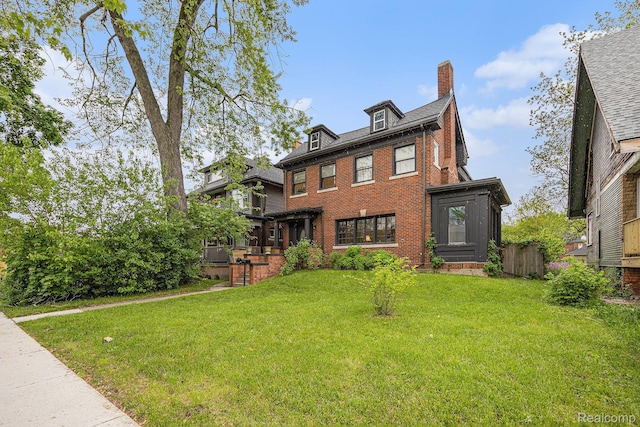 2223 S La Salle Gdns, Detroit, MI 48206 - view of front of home featuring a chimney, brick siding, and a front lawn
