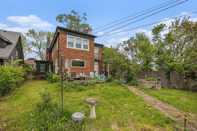 2223 S La Salle Gdns, Detroit, MI 48206 - back of property featuring brick siding, a chimney, and outdoor lounge area