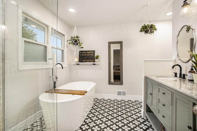 830 E Lyons St, Schoolcraft, MI 49087 - full bath featuring tile patterned floors, a soaking tub, vanity, tiled shower, and baseboards