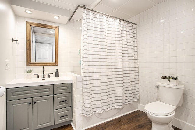 830 E Lyons St, Schoolcraft, MI 49087 - bathroom with tile walls, toilet, vanity, wood finished floors, and recessed lighting
