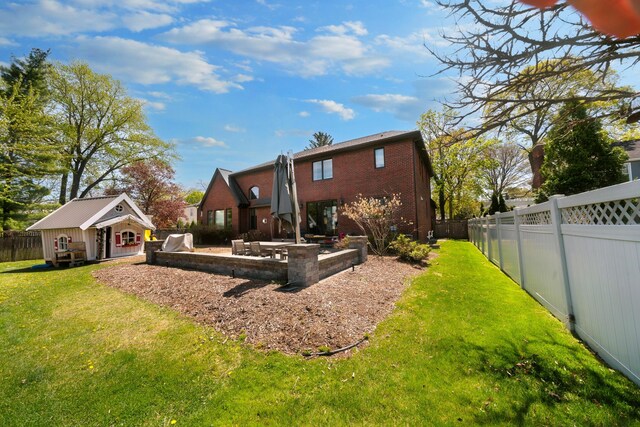 1655 Dorchester Rd, Birmingham, MI 48009 - back of property featuring a patio area, an outdoor structure, and brick siding