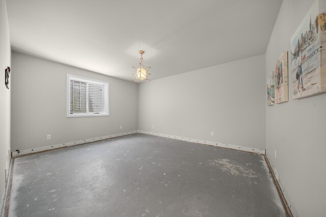 1655 Dorchester Rd, Birmingham, MI 48009 - unfurnished room featuring unfinished concrete flooring, baseboards, and a chandelier