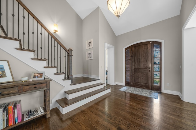 1655 Dorchester Rd, Birmingham, MI 48009 - foyer entrance featuring high vaulted ceiling, wood finished floors, arched walkways, baseboards, and stairs