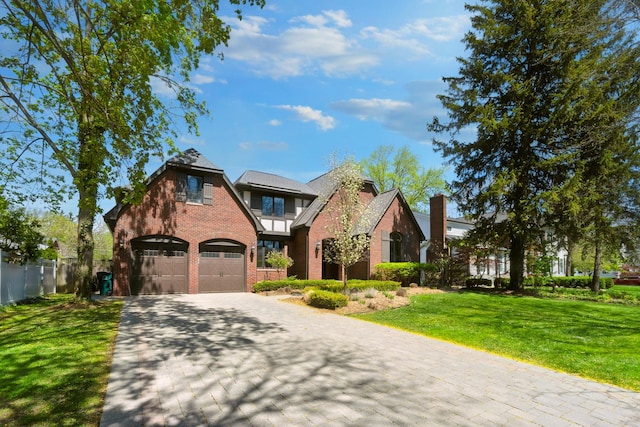 1655 Dorchester Rd, Birmingham, MI 48009 - tudor-style house with brick siding, decorative driveway, and a garage