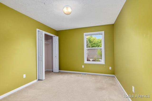 11081 Timberline Dr, Allendale, MI 49401 - unfurnished bedroom with carpet floors, a textured ceiling, baseboards, and a closet