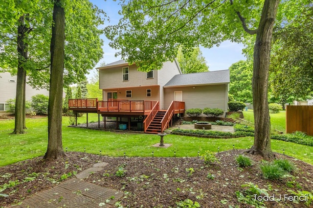 11081 Timberline Dr, Allendale, MI 49401 - rear view of house featuring a wooden deck, a fire pit, a lawn, and stairs