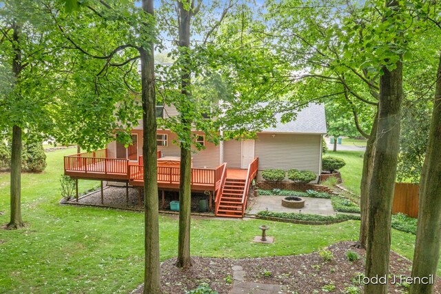 11081 Timberline Dr, Allendale, MI 49401 - view of grassy yard with an outdoor fire pit, a deck, and stairs