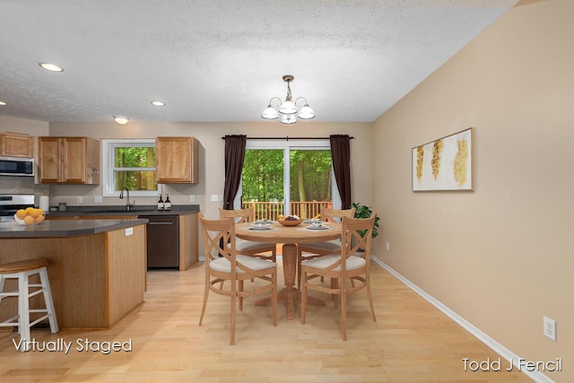 11081 Timberline Dr, Allendale, MI 49401 - dining space featuring light wood-style floors, a textured ceiling, a chandelier, healthy amount of natural light, and recessed lighting
