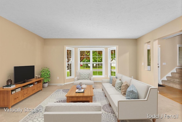 11081 Timberline Dr, Allendale, MI 49401 - living room with light colored carpet, a textured ceiling, stairway, and baseboards