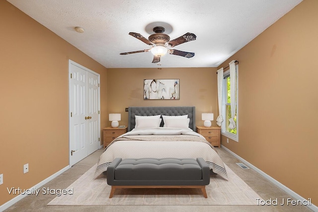 11081 Timberline Dr, Allendale, MI 49401 - bedroom featuring light colored carpet, baseboards, a closet, ceiling fan, and a textured ceiling