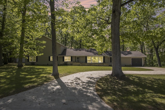 15842 Portage Rd, Vicksburg, MI 49097 - view of front facade featuring curved driveway, an attached garage, and a yard