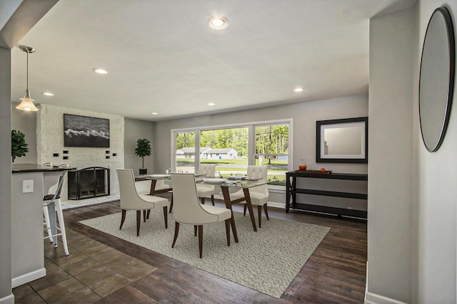 15842 Portage Rd, Vicksburg, MI 49097 - dining space with a stone fireplace, baseboards, recessed lighting, and dark wood-style floors