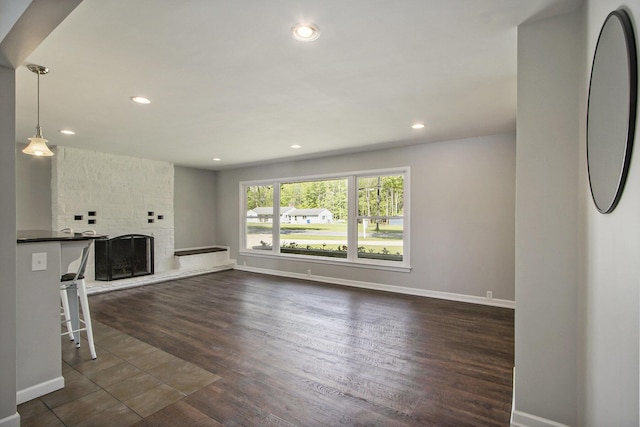 15842 Portage Rd, Vicksburg, MI 49097 - unfurnished living room with baseboards, dark wood-style flooring, recessed lighting, and a fireplace