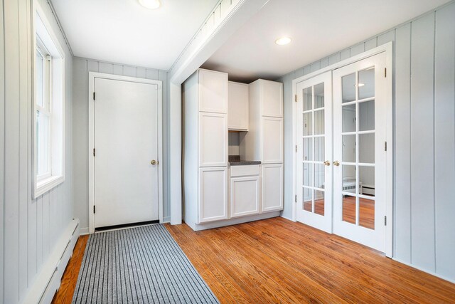 15842 Portage Rd, Vicksburg, MI 49097 - doorway featuring french doors, light wood-type flooring, and a baseboard radiator