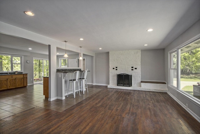 15842 Portage Rd, Vicksburg, MI 49097 - living room featuring a fireplace, recessed lighting, dark wood-style flooring, and baseboards