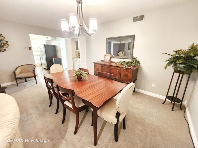 9135 Greenway Blvd, Saginaw, MI 48609 - dining area with light colored carpet, a chandelier, and baseboards
