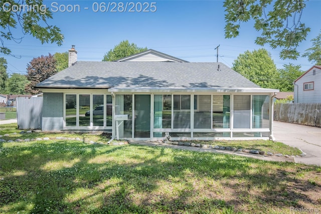 36426 Weideman St, Clinton Township, MI 48035 - view of front of property featuring a sunroom, a chimney, a shingled roof, and brick siding